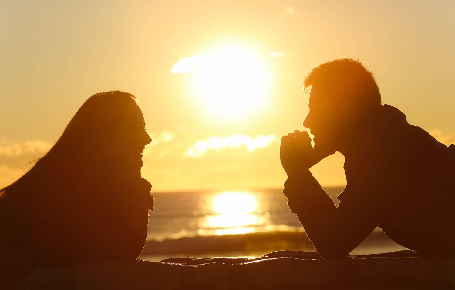 Working from home with loved ones in a pandemic, prioritize communication, listening & dealing with conflicts improves relationships. (image: couple at sunset)