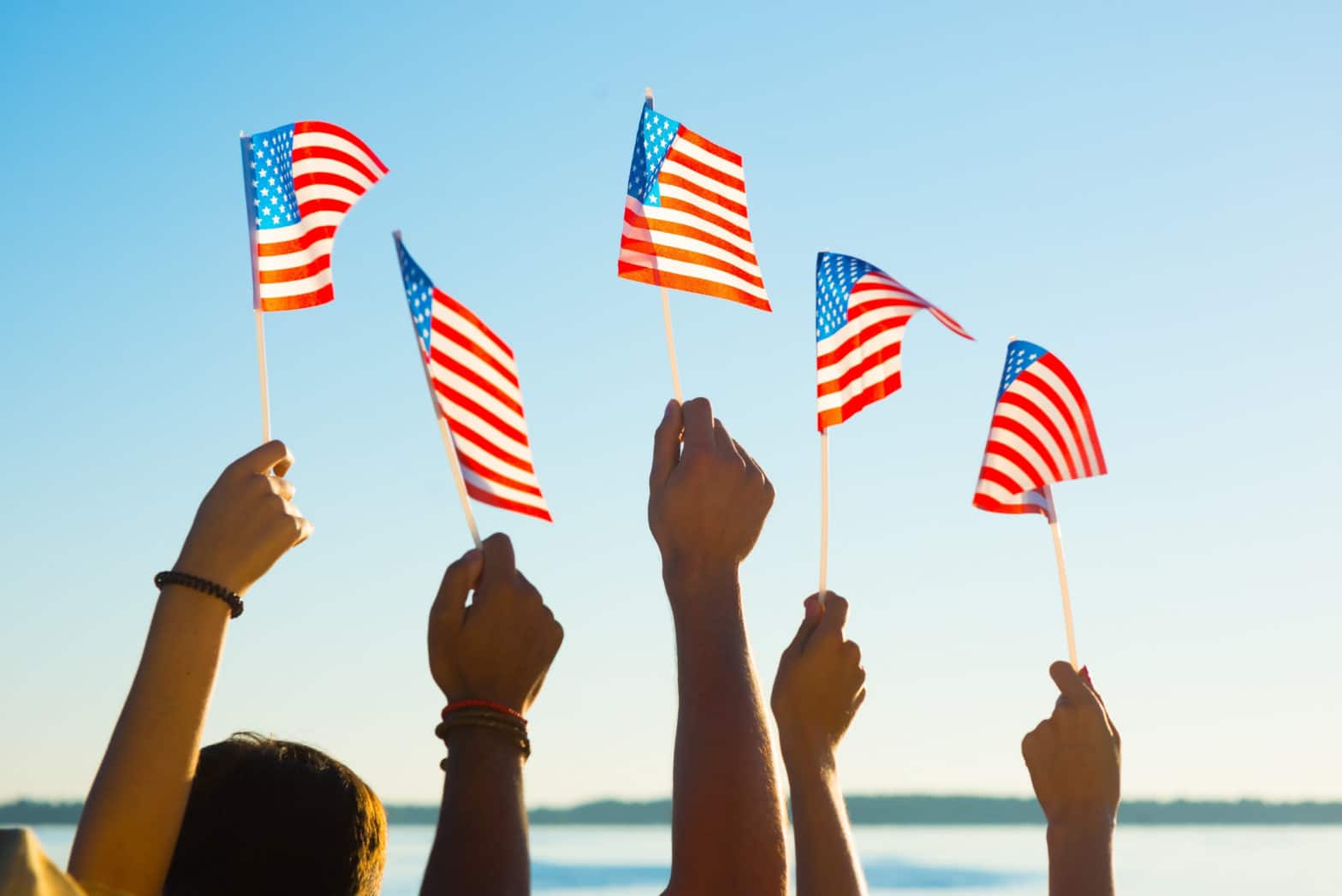 Brand Principles are the foundation for a country, a business, structures, disciplines & habits, a brand. (American flags held up in diverse hands)