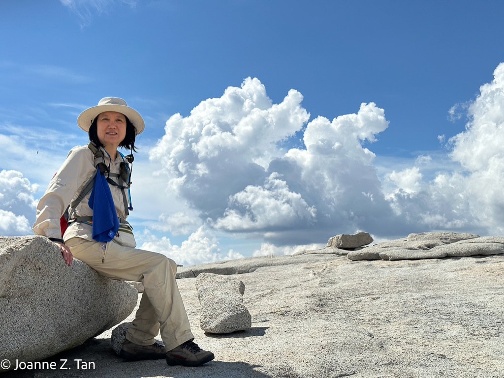On top of Half Dome in the white clouds upon climbing up Joanne Z. Tan, writer, award-winning photographer & poet, global top brand strategist, branding expert.