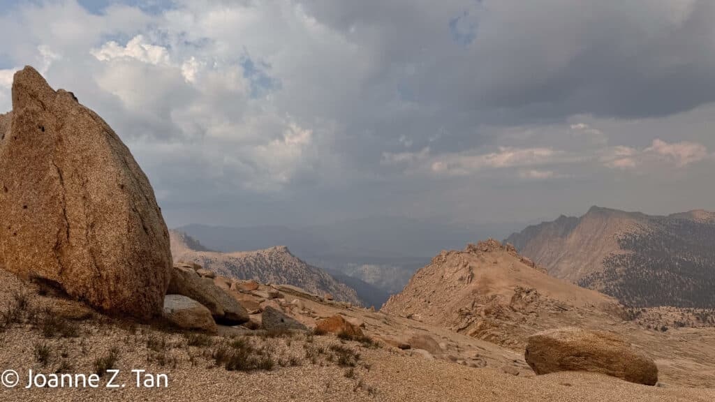 The boulders and distant mountain ranges in the High Sierra, a true adventure story by Joanne Z. tan Pt 1 of 3, about backpacking and hiking.